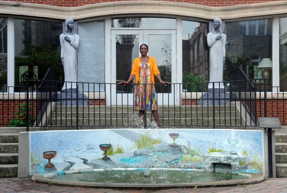 Marian House resident Patricia Bishop stands in the healing garden