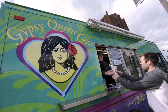 Gypsy Queen Caf�'s J.A. Peters, left, hands a Gypsy Crab Cone to Matt Groncki