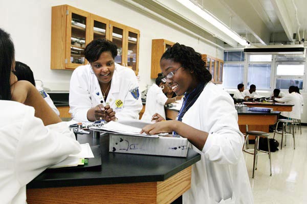 Vivian T. Thomas Medical Arts High School Principal Dr. Starletta Jackson with a student in biology