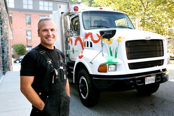 Keith Losoya with Waste Neutral Group stands with his new work truck 